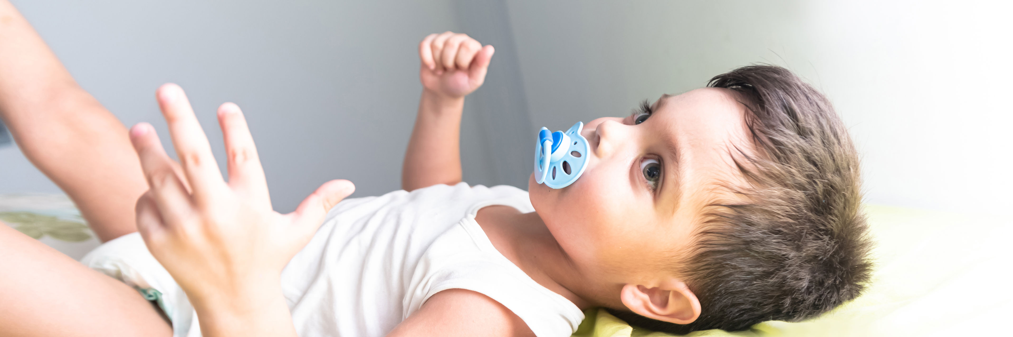 Dreng, der ligger ned med blå sut i munden